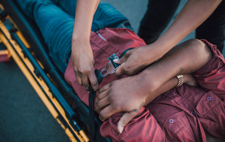 Paramedics helping a victim of a motor vehicle accident