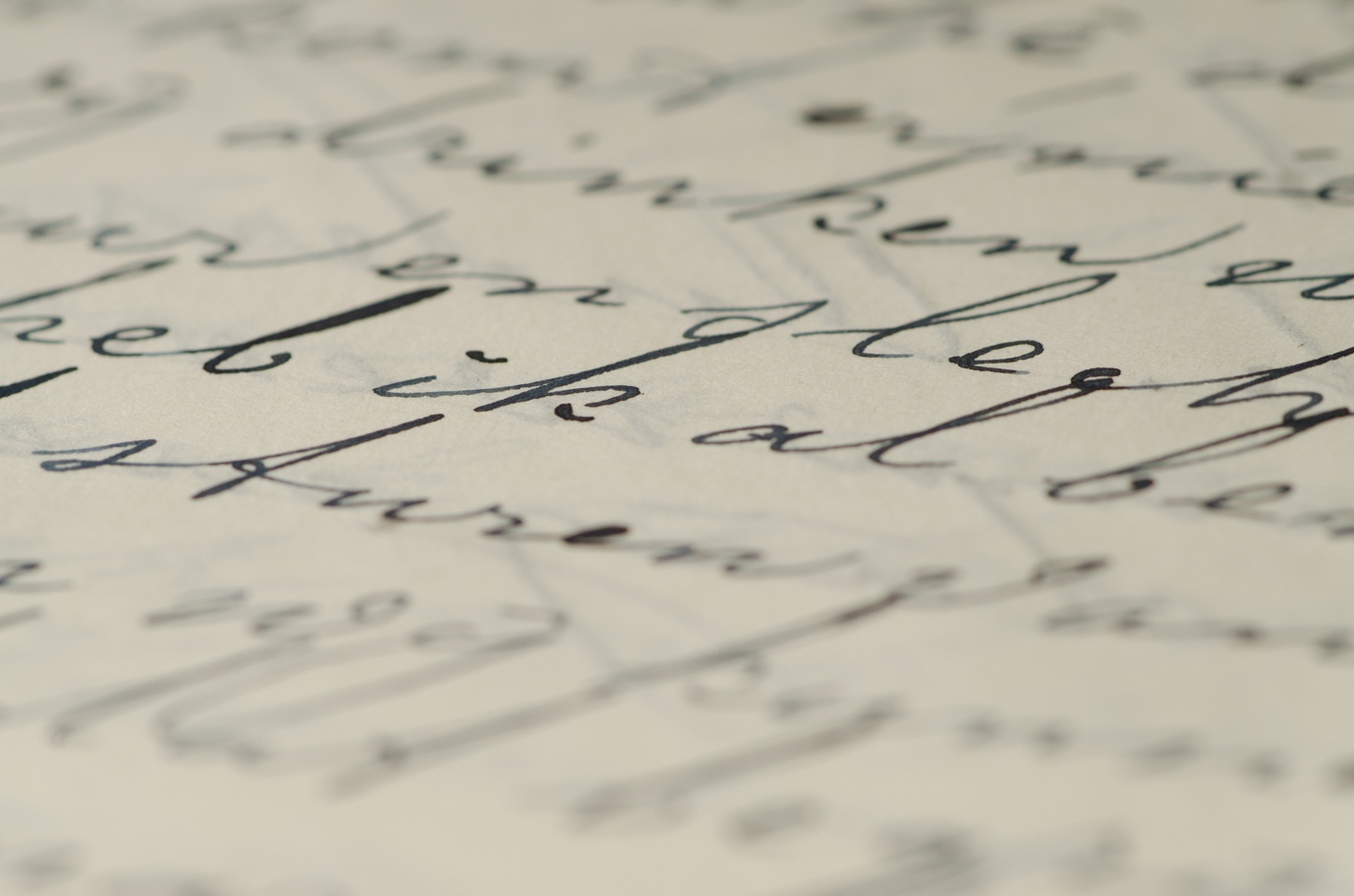 Closeup of cursive words written on paper with a fountain pen