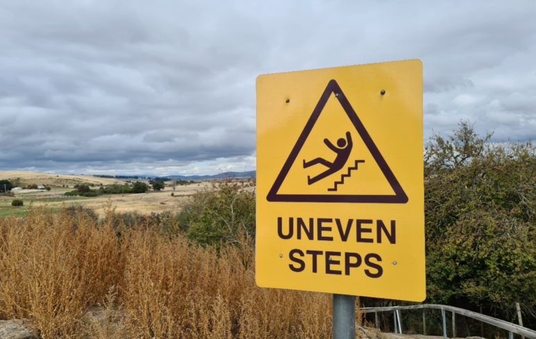 A warning signboard of uneven steps