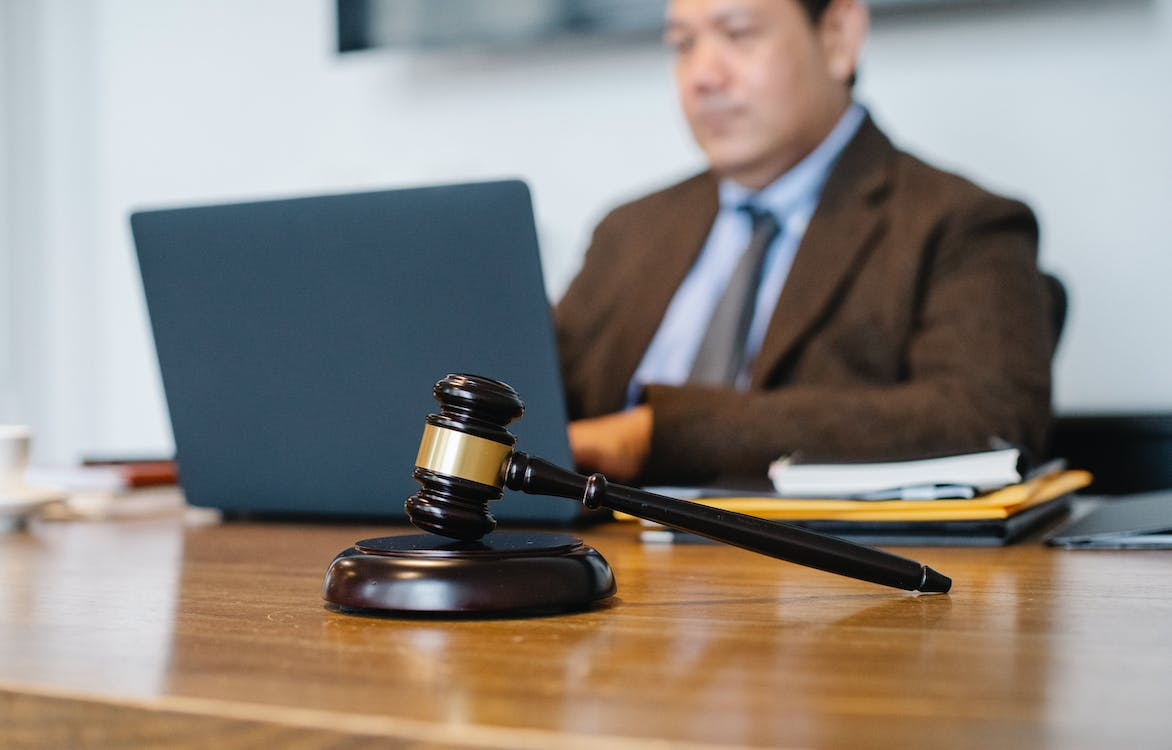 A lawyer in the background with a gravel at the front