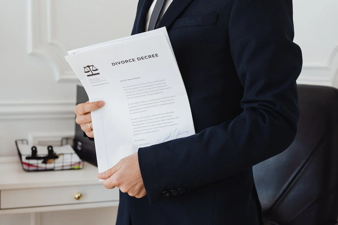 An experienced divorce lawyer holding documents