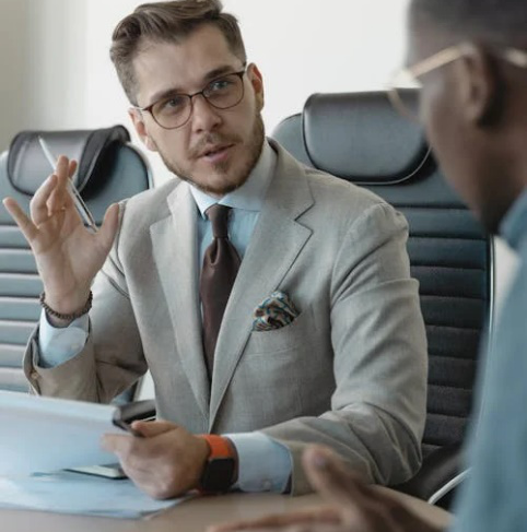 An image of two men talking in an office