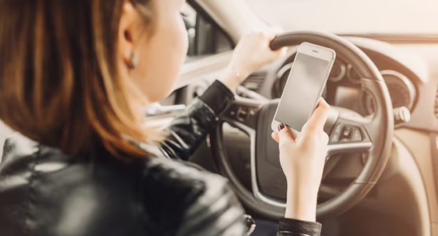A woman texting while driving