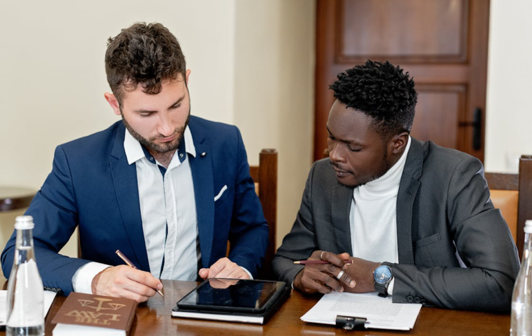Men research a lemon law case.