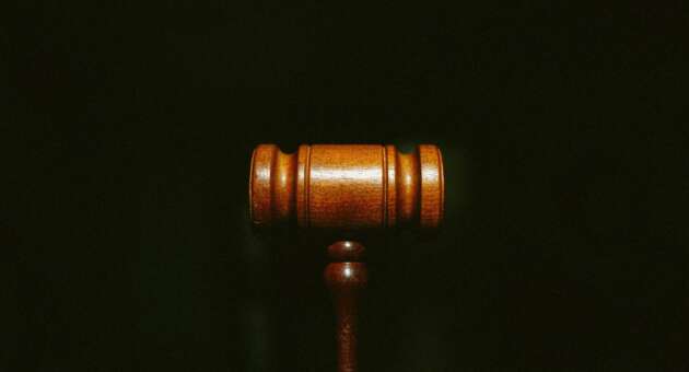 An image of a gavel against a black background.