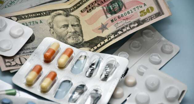 A close-up image of pills and dollar bills