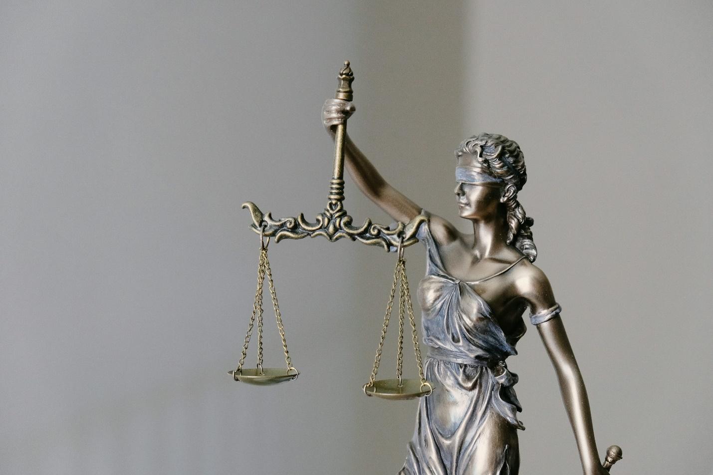 An image of a lady of justice statue holding a balance. An image of a lady of justice statue holding a balance.