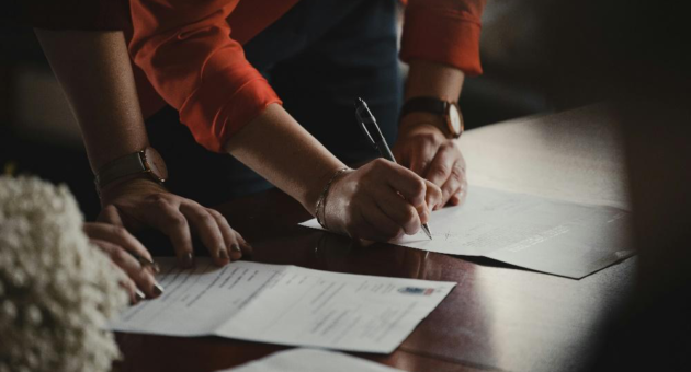 Business owner reviewing paperwork for a potential Lemon Law claim in California.
