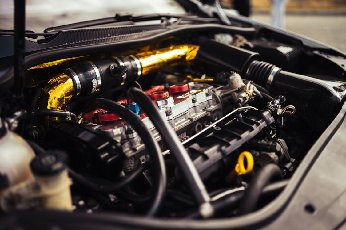 Close-up of a car engine being inspected for defects after a dealership trade-in purchase in California