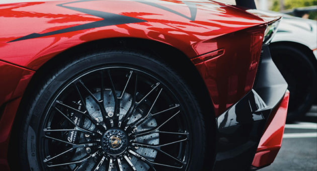A black and red Lamborghini Aventador parked outdoors