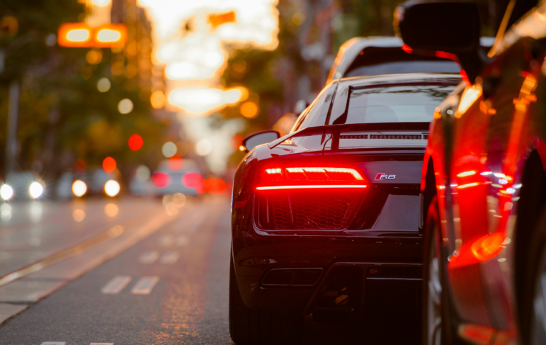 A black Audi parked beside a road