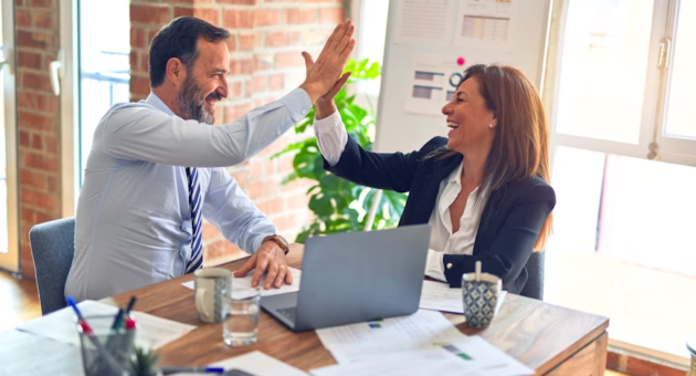 2 people high-fiving each other