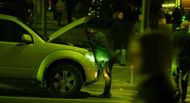 Checking a vehicle after an unexpected roadside breakdown.