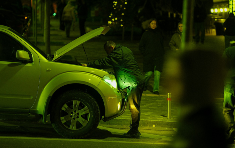 Checking a vehicle after an unexpected roadside breakdown.